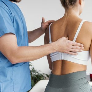 side-view-male-osteopathic-therapist-checking-female-patient-s-scapula-bone side-view-male-osteopathic-therapist-checking-female-patient-s-scapula-bone